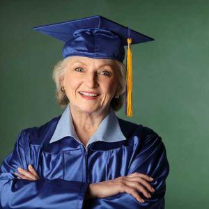 senior woman in graduation cap and gown